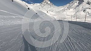 first person view downhill skiing mountain slope in Alps. Freeride skier skiing in backcountry mountain ski resort.