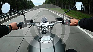 First person view of driving on a motorbike at the highway through the forest