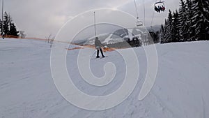 First-person view on Skiers and Snowboarders Slide Down on Ski Slope at Ski Resort