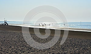 The first rays of the sun on the sea and on the beach