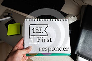 First responder word on notebook holding man against desktop