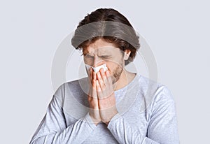 First signs of disease. Guy blows his nose in napkin