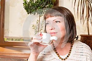 First sip. Portrait of a young woman drinking her morning coffee over a breakfast in the kitchen