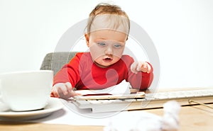 Happy child baby girl toddler sitting with keyboard of computer isolated on a white background