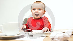 Happy child baby girl toddler sitting with keyboard of computer isolated on a white background