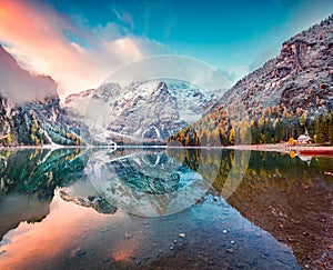 First snow on Braies Lake. Colorful autumn landscape in Italian Alps, Naturpark Fanes-Sennes-Prags, Dolomite, Italy, Europe.