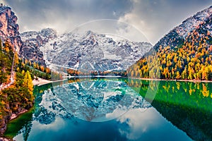 First snow on Braies Lake. Colorful autumn landscape in Italian Alps, Naturpark Fanes-Sennes-Prags, Dolomite, Italy, Europe.