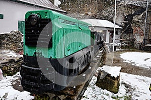 First snow falling on historical small mine train used for transport of ore wagons, now displayed as exhibit