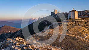 First snow at Gran Sasso National park: Calascio Castle and a church