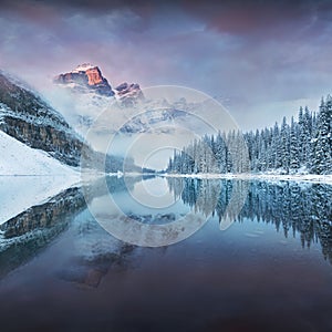 First snow Morning at Moraine Lake in Banff National Park Alberta Canada. Snow-covered winter mountain lake in a winter atmosphere