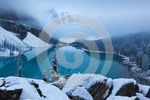 First snow Morning at Moraine Lake in Banff National Park Alberta Canada Snow-covered winter mountain lake in a winter atmosphere.