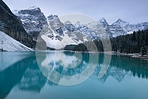 First snow Morning at Moraine Lake in Banff National Park Alberta Canada Snow-covered winter mountain lake in a winter atmosphere.