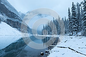 First snow, Morning at Moraine Lake in Banff National Park Alberta Canada Snow-covered winter mountain lake in a winter atmosphere