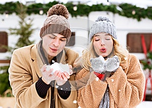 First Snowfall. Young Romantic Couple Playing With Snow, Enjoying Winter Day Outdoors