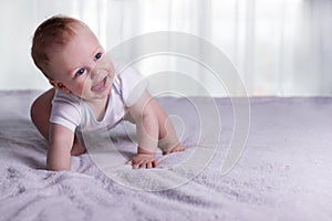 First steps of funny baby boy. Cute infant kid begining to toddle. Cute toddler in good mood. Copy space. photo