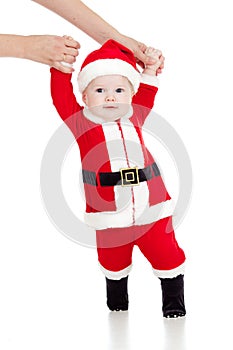 First steps of funny Santa claus baby boy