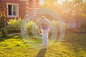 First steps of little adorable toddler boy, Happy and cute baby learning to walk with mother, mother`s day concept