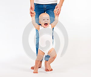 First steps. Little baby girl learning to walk