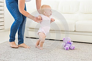 First steps. Little baby girl learning to walk.
