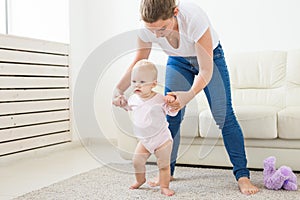 First steps. Little baby girl learning to walk.