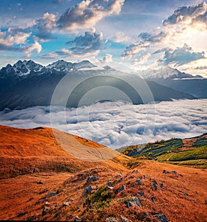 First sunlight glowing foggy walley in Caucasus mountains, Koruldi lakes location. photo