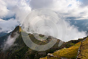 First sunlight on Machu Picchu from opening clouds