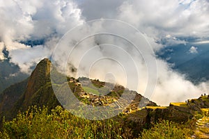 First sunlight on Machu Picchu from opening clouds