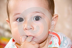 First teeth grow a baby 7 month old boy. was crying and biting your fingers, climb