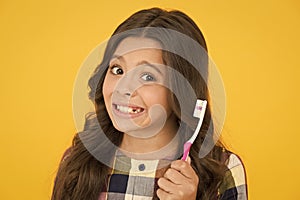 First thing to do in morning. Happy child brush teeth in morning. Little girl smiling with tooth brush. Oral hygiene and