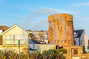 First tower of round coastal defence line with residential district in the background, bailiwick of Jersey, Channel Islands, Great