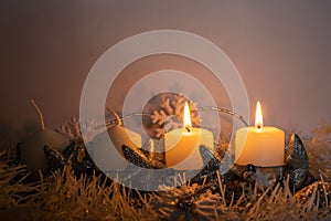 The first two candles burning on a home made advent wreath