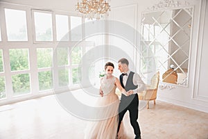 First wedding danc.wedding couple dances on the studio. Wedding day. Happy young bride and groom on their wedding day.