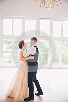 First wedding danc.wedding couple dances on the studio. Wedding day. Happy young bride and groom on their wedding day.