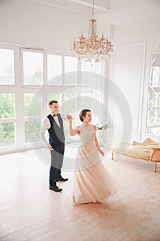 First wedding danc.wedding couple dances on the studio. Wedding day. Happy young bride and groom on their wedding day.