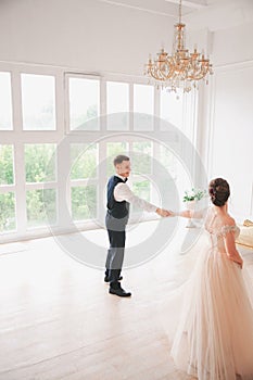 First wedding danc.wedding couple dances on the studio. Wedding day. Happy young bride and groom on their wedding day.