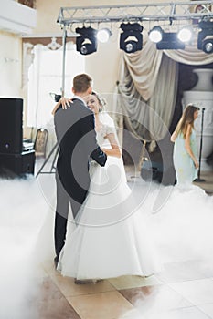 First wedding dance of newlywed couple in restaurant