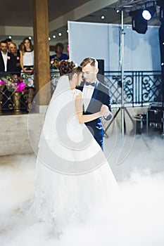 First wedding dance of newlywed couple in restaurant