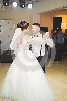 First wedding dance of newlywed couple in restaurant