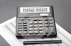 FISCAL POLICY word on the calculator on the chart with pen