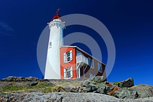 Victoria, Vancouver Island, Fisgard Lighthouse with Flowers and Blue Sky, Fort Rodd Hill National Historic Site, British Columbia photo