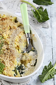 Fish baked with potatoes and spinach. fish pie.