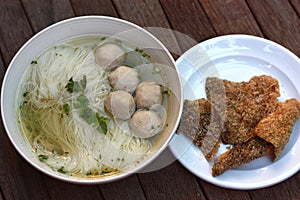 Fish balls noodles served with fried fish skin