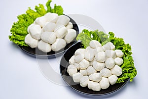 Fish balls ready to be served in a white container.