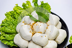 Fish balls ready to be served in a white container.