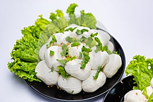 Fish balls ready to be served in a white container.