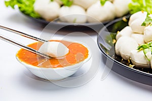 Fish balls ready to be served in a white container.