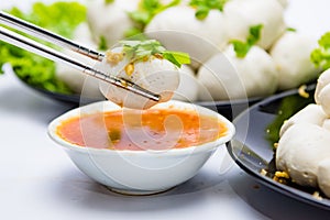 Fish balls ready to be served in a white container.