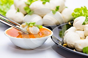 Fish balls ready to be served in a white container.