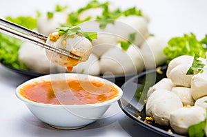 Fish balls ready to be served in a white container.