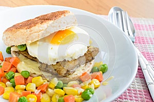 Fish Burger with fried eeg serving boiled mix vegetable